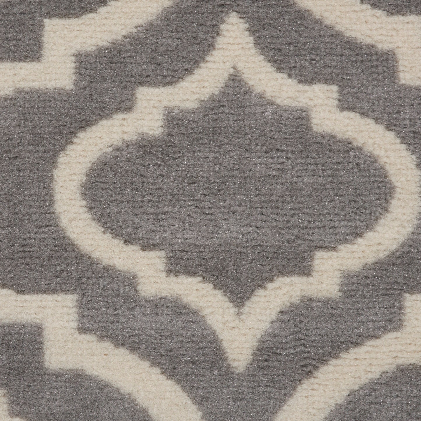 Grey rug with cream Moroccan trellis motif and plush pile; decorative geometric floor covering.