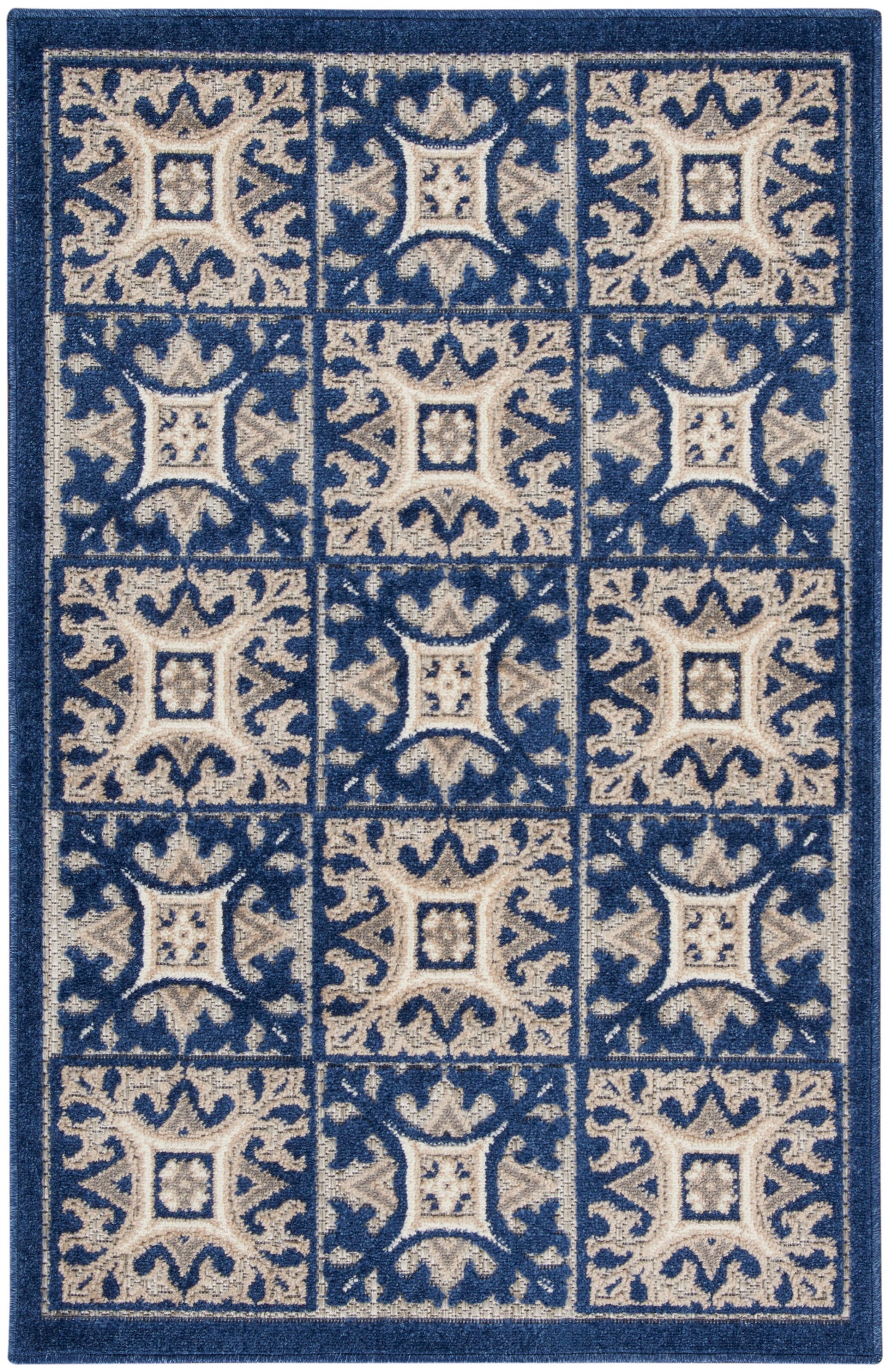 Blue and beige patterned area rug with tiled square blocks and ornate scrollwork in a grid.