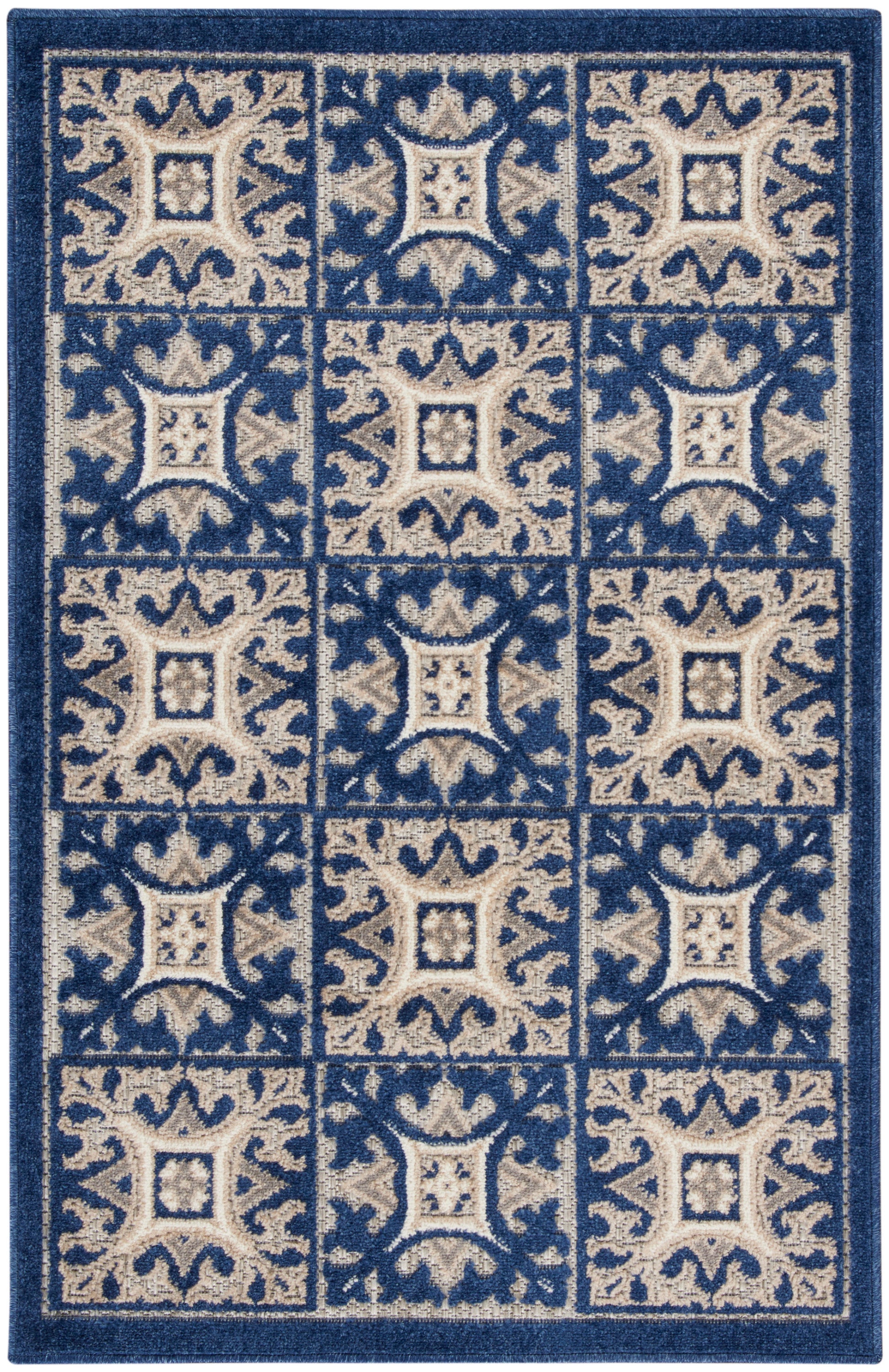 Blue and beige patterned area rug with tiled square blocks and ornate scrollwork in a grid.