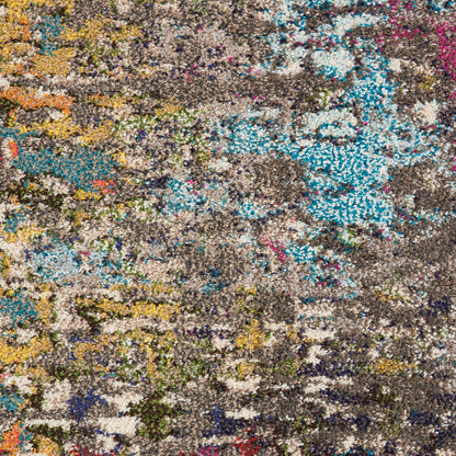 Colorful abstract tufted rug with a brown base and vibrant teal, blue, yellow, orange, and pink patches.