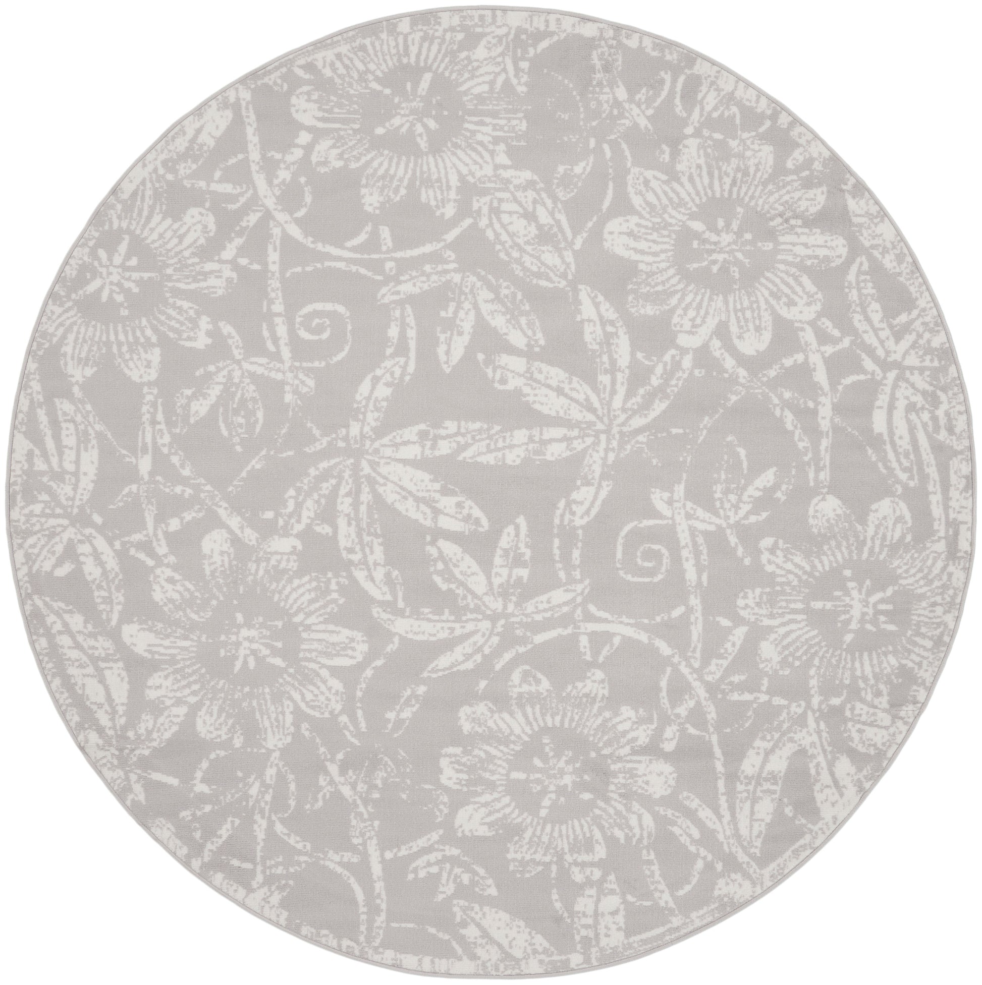 Round placemat with subtle white floral damask pattern on light gray background.
