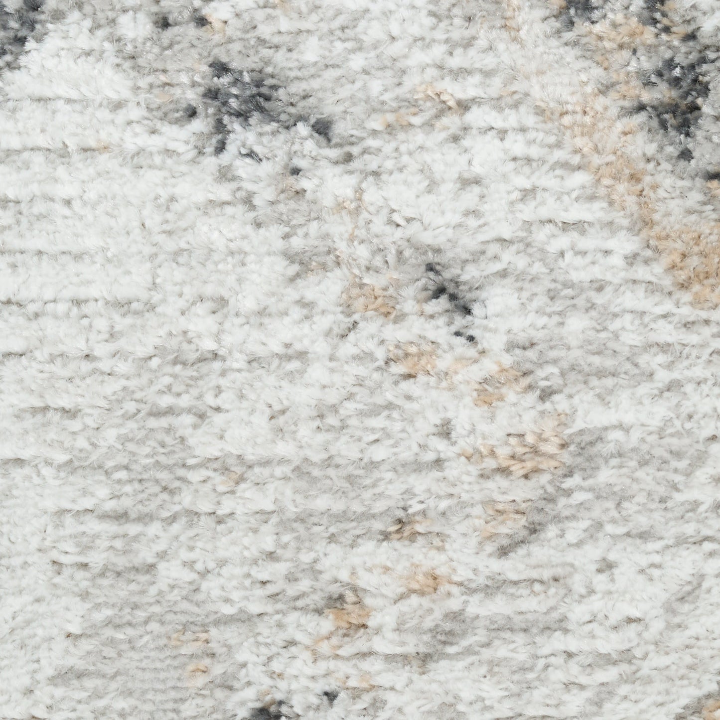 Close-up of a plush shag rug in light gray with cream and beige accents, fluffy pile and subtle marbled pattern.