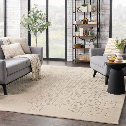 Neutral living room with beige geometric rug, gray sofas, black metal bookcase, potted plant & large windows.