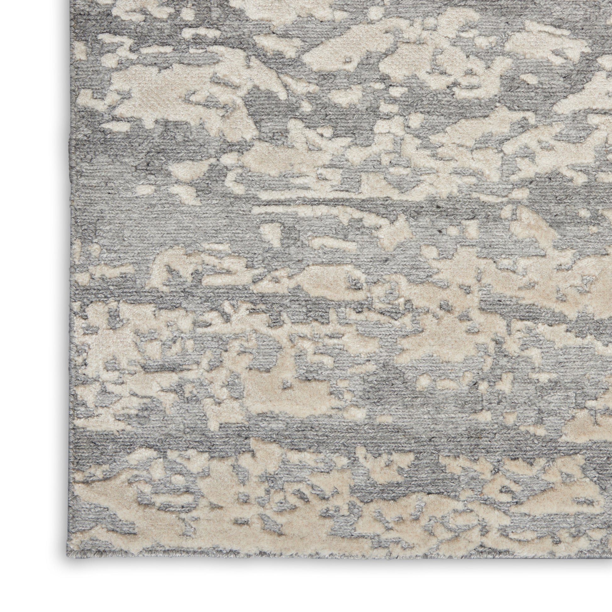 Gray and cream abstract patterned rug with a soft, textured pile; rectangular, modern living-room decor.