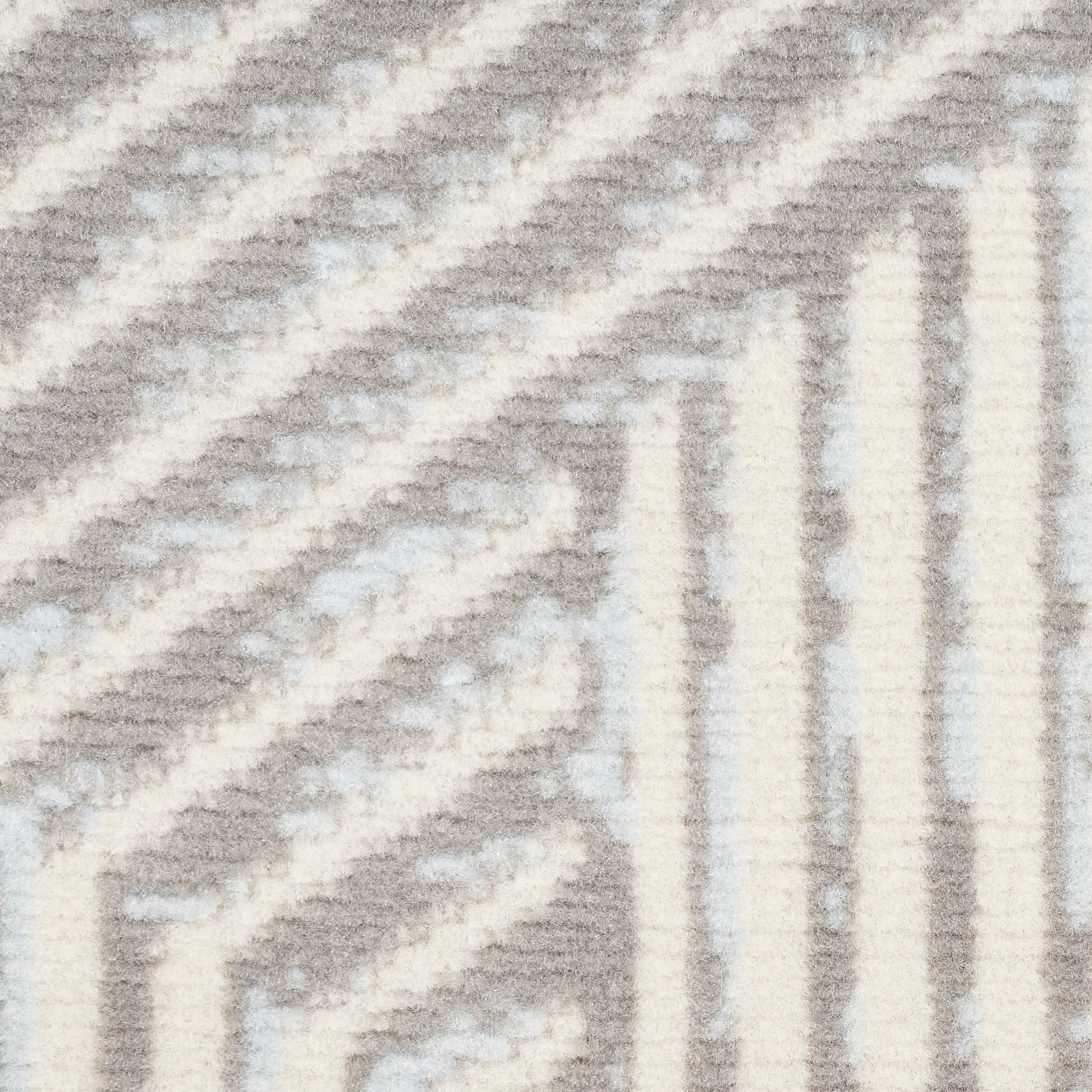 Cream and light gray woven rug featuring a geometric chevron pattern and soft texture.