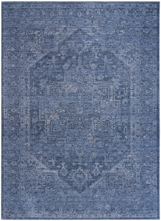 Blue distressed oriental rug with faded vintage pattern; rectangular area rug with denim tones and soft woven texture.