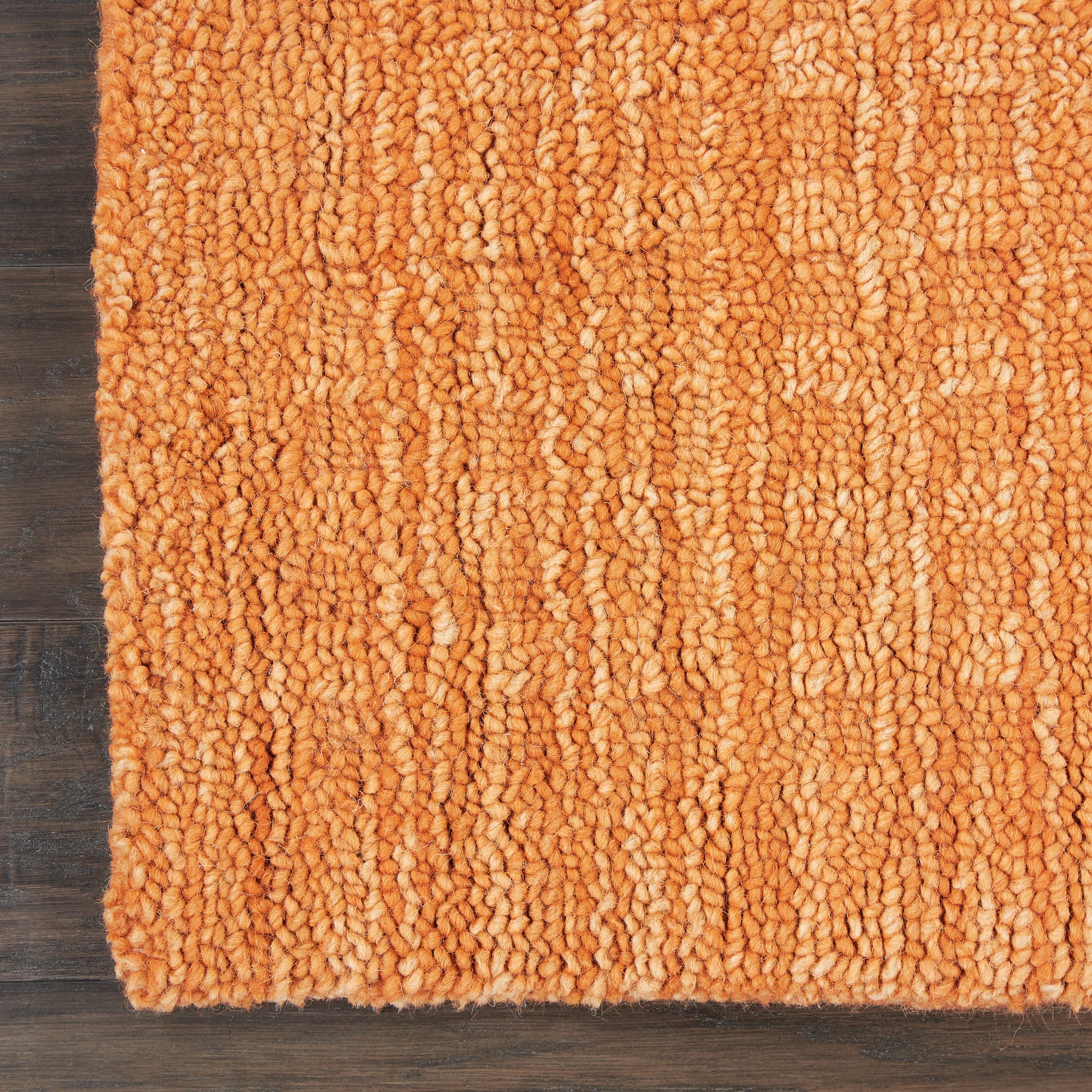 Orange shag 8-foot runner rug with thick loop pile on dark wood floor; plush cozy living room accent.