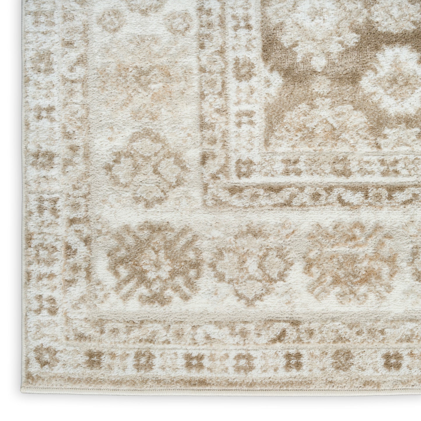 Cream-beige Persian-style rug with subtle floral medallions and bordered motif, plush textured pile.