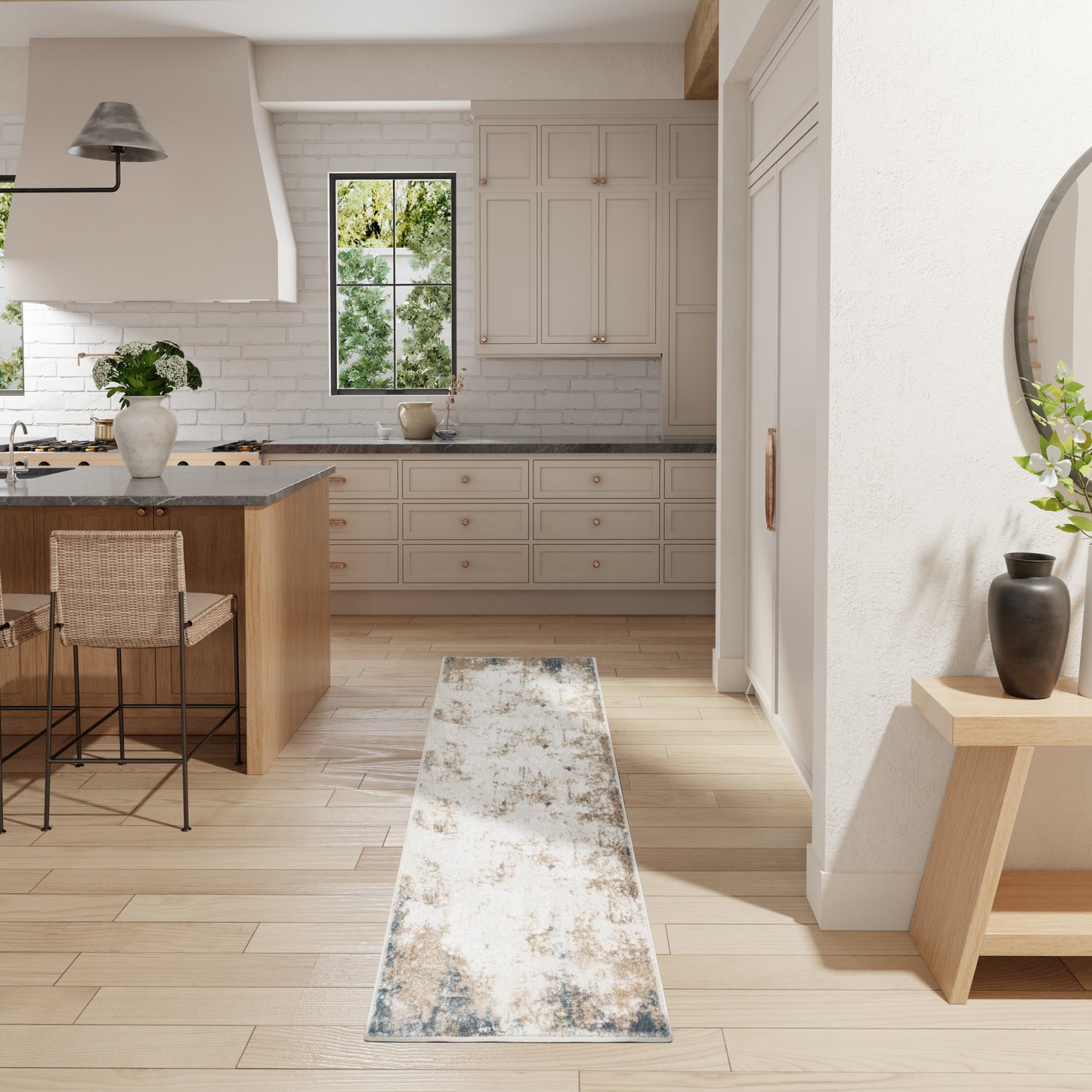Bright modern farmhouse kitchen with white cabinets, light wood island, bar stools, window, and distressed blue runner rug.