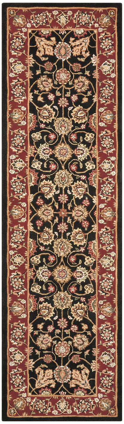 Persian-style rug runner: black central field with gold floral motifs, red ornate border, long narrow hallway rug.