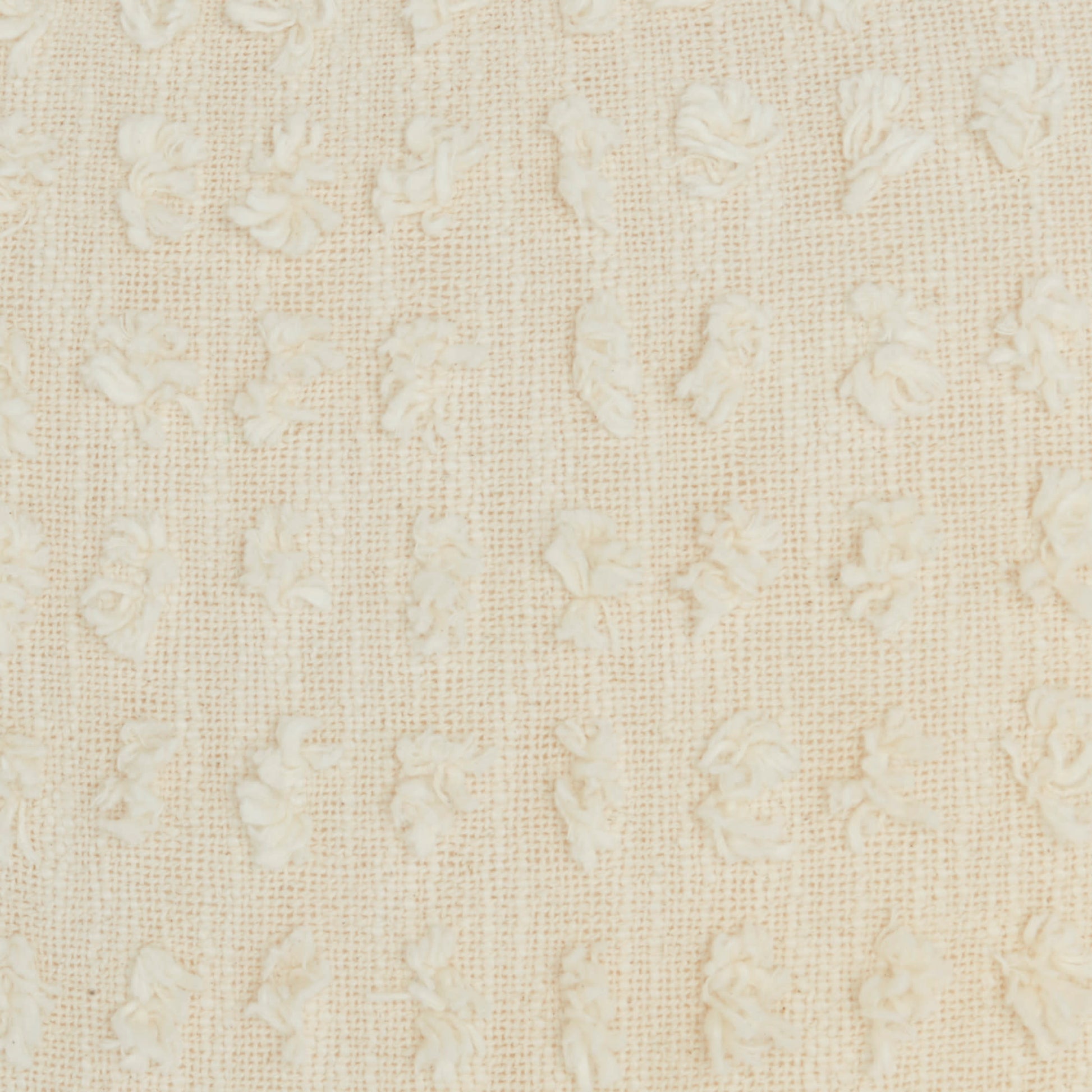Cream-colored woven fabric with tiny raised floral motifs and a soft damask-like texture, suitable for upholstery or curtains.