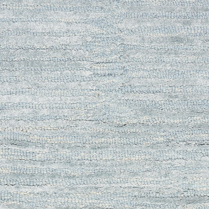 Light blue-gray terry cloth fabric with dense plush loops, close-up.