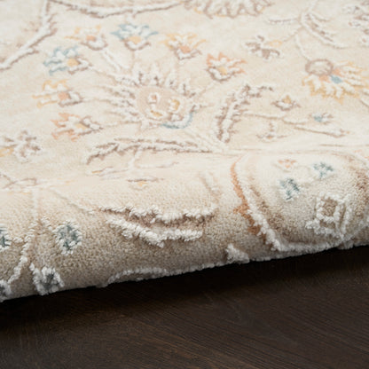Cream Persian-style rug with pastel peach and pale blue floral pattern, plush pile, fringed edge.