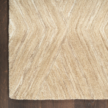 Beige textured rug with a chevron/zigzag pattern and loop pile, shown on dark wood flooring.