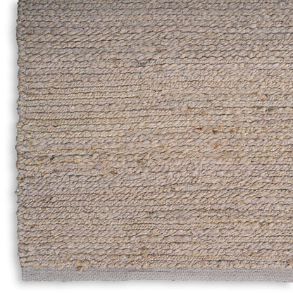 Natural beige loop-pile jute rug (4' x 6') with subtle texture and light gray backing, rectangular for casual living spaces.