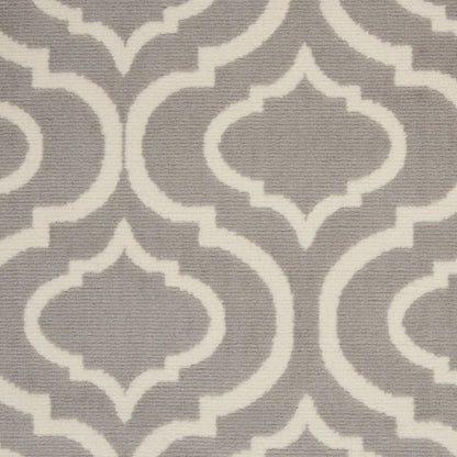 Woven taupe fabric with white Moroccan quatrefoil lattice pattern.