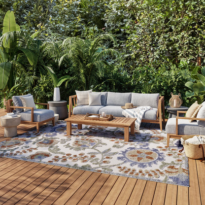 Outdoor 6' x 9' rug with a woven floral pattern in tropical colors.