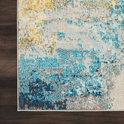 Abstract multicolor area rug featuring yellow, teal, and blue hues on a cream base, on dark wood floor.