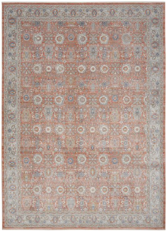 Rectangular oriental rug with peach field and ivory-blue floral medallions; pale gray-blue border in vintage Persian style.