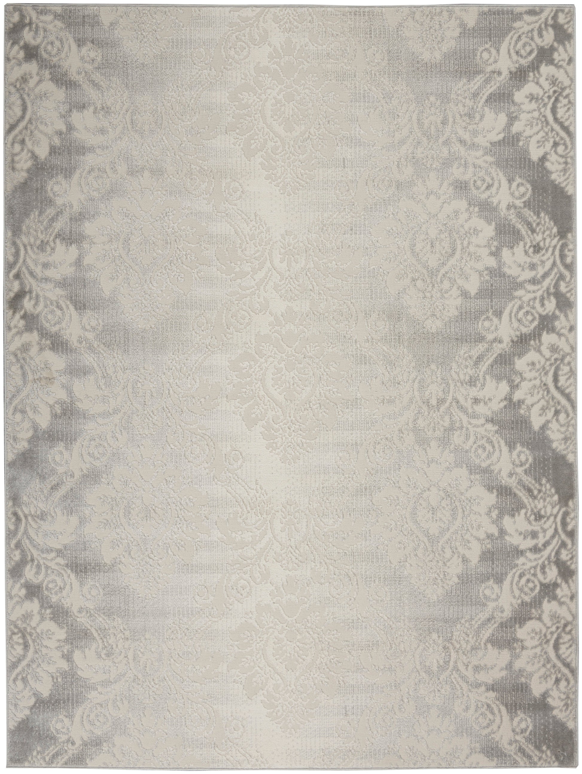 Cream-beige damask area rug with subtle gray ornate border and soft woven texture.