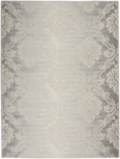 Cream-beige damask area rug with subtle gray ornate border and soft woven texture.