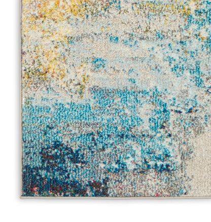 Abstract blue and yellow area rug with cream base, distressed textured pattern and soft woven surface.