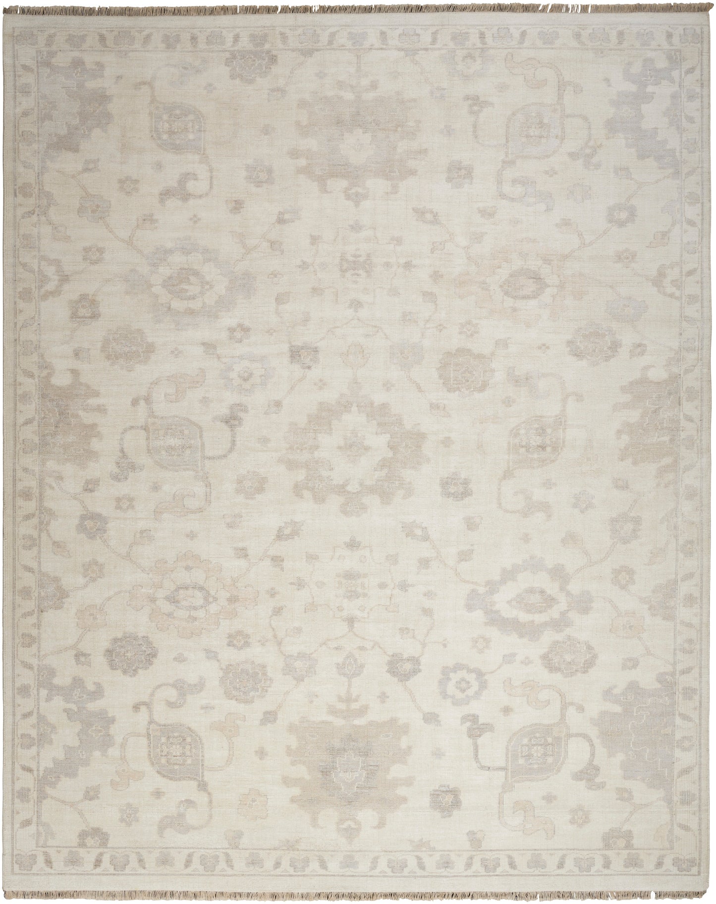 Ivory area rug with a subtle gray damask floral pattern and fringed border.