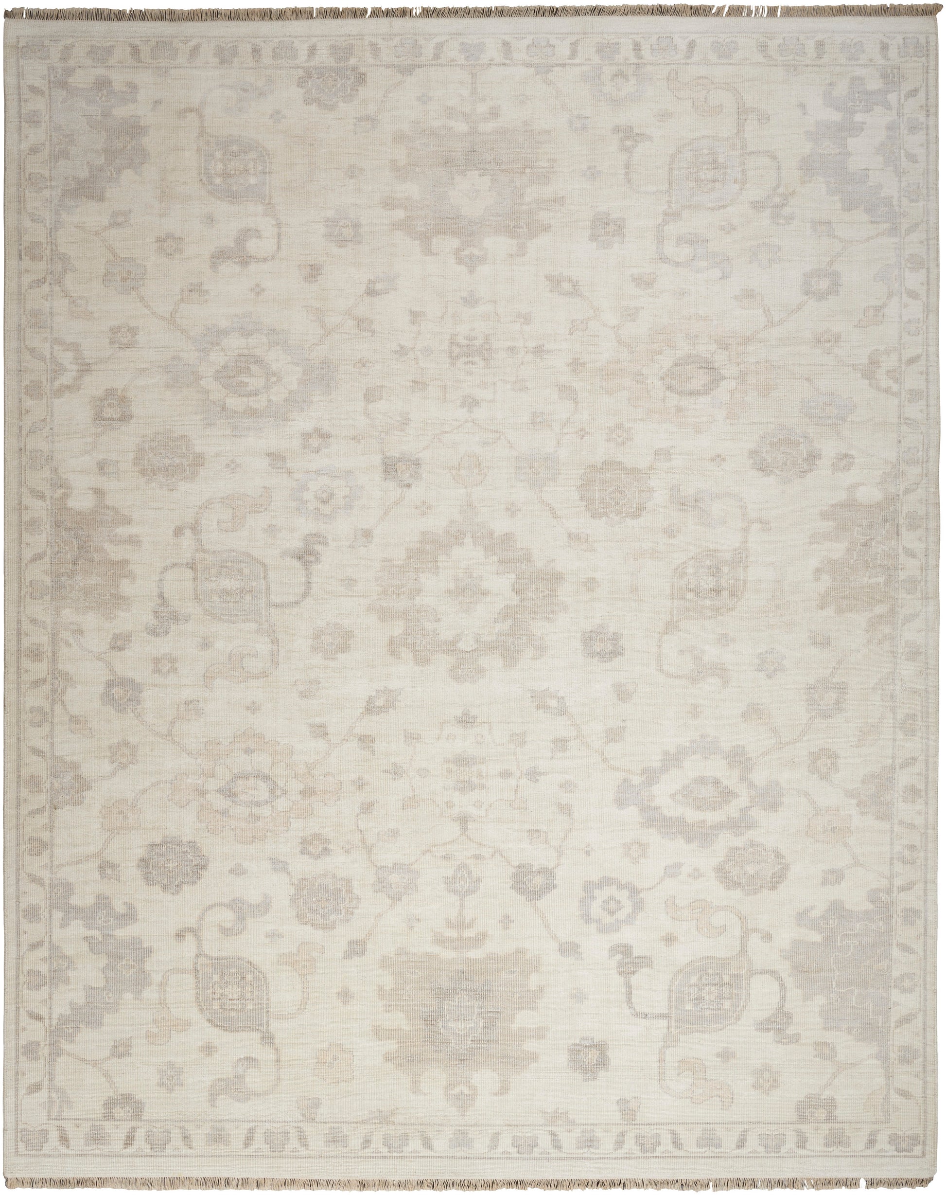 Ivory area rug with a subtle gray damask floral pattern and fringed border.