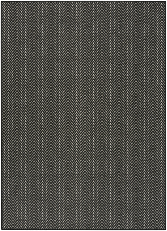 Dark charcoal and beige chevron rug with zigzag weave; rectangular, textured floor covering.