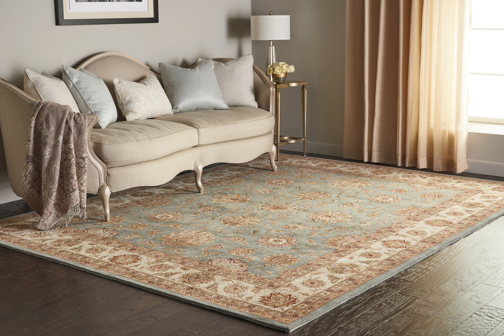 Cream and blue oriental rug in a living room scene; size 8' x 10'.