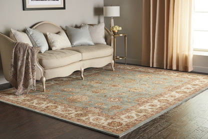 Cream and blue oriental rug in a living room scene; size 8' x 10'.