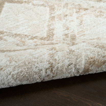 Cream shag rug with plush high-pile texture on dark wood floor, modern cozy style, 8' x 10'.