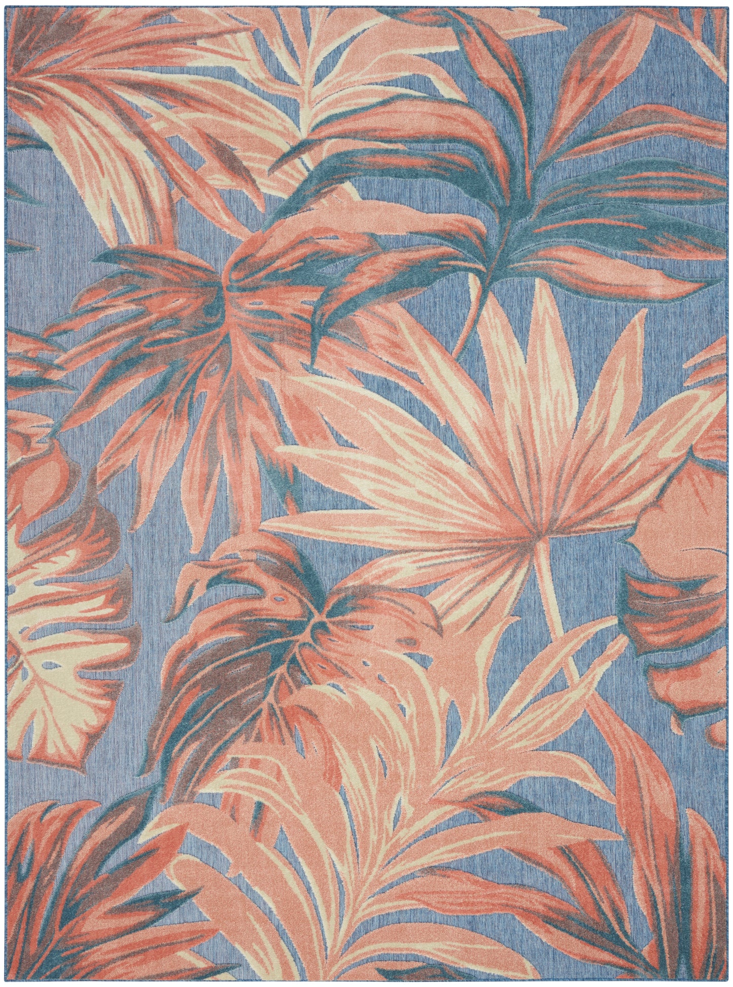 Rectangular coral-peach tropical leaf rug on blue background; woven texture, bold botanical print.
