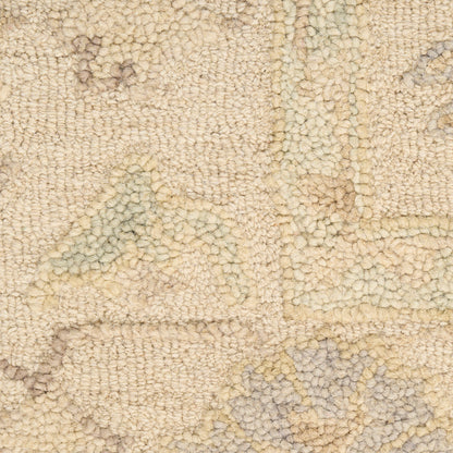 Beige textured rug with cream and pale blue geometric motifs; soft looped pile.