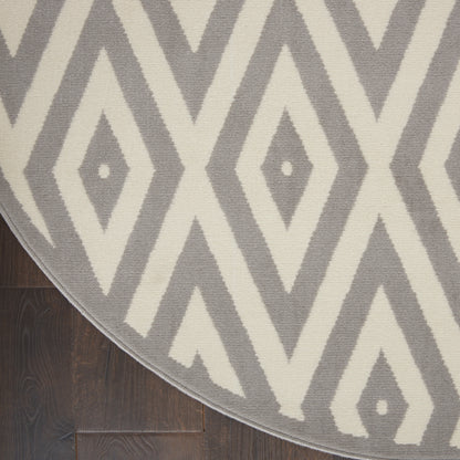 Round area rug, 8' diameter, with a grey and ivory diamond geometric pattern on a dark wood floor.