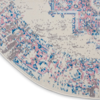 Round cream rug with abstract pink, blue, and gray floral pattern; soft plush pile.