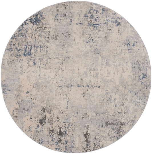 Round area rug with abstract distressed pattern in beige, gray and blue-gray tones.