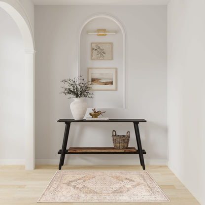 Black mid-century console in an arched alcove with pale walls; vase with greenery, wicker basket, framed prints, beige rug.