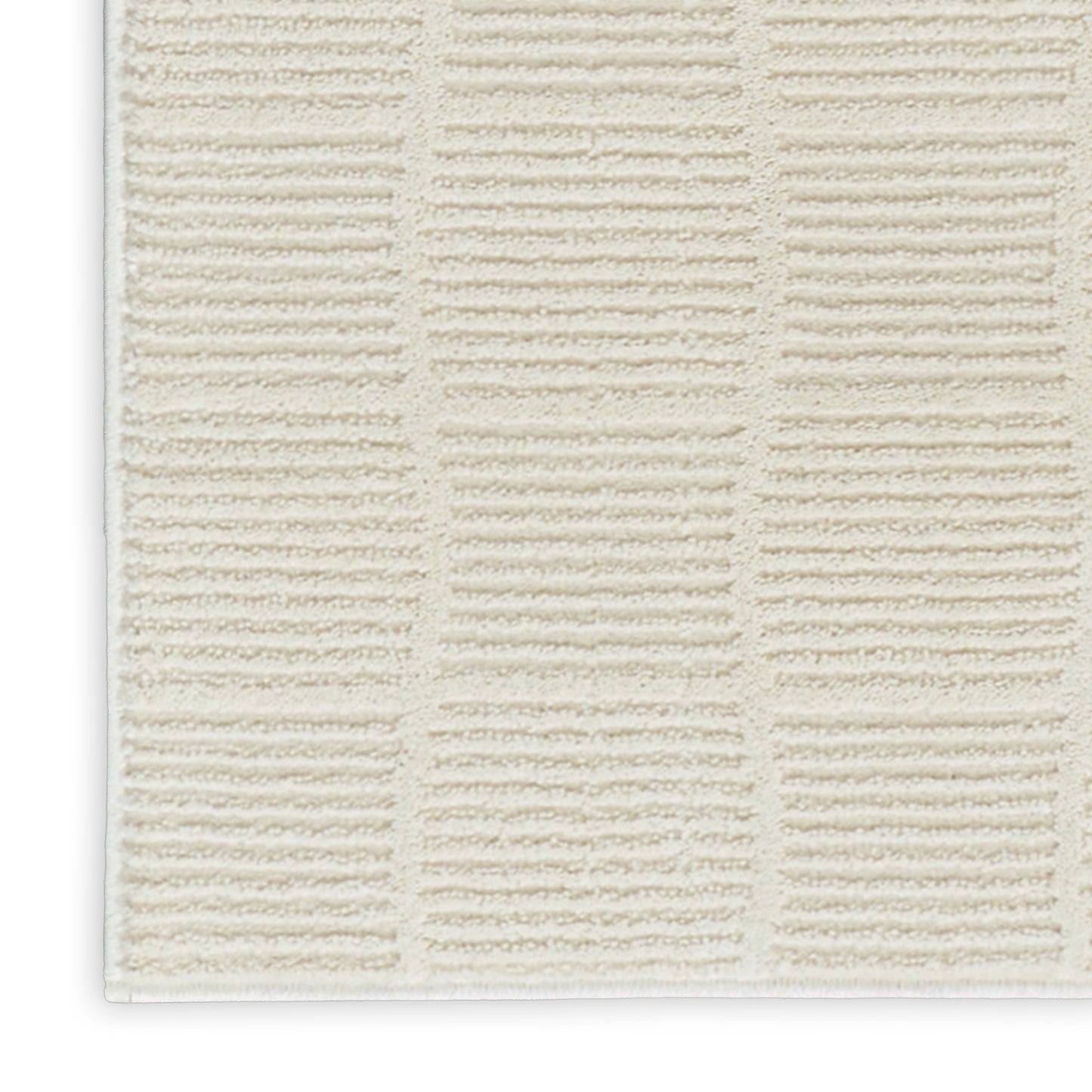 Cream textured bath mat with a grid of tufted rectangular blocks; plush bathroom rug.