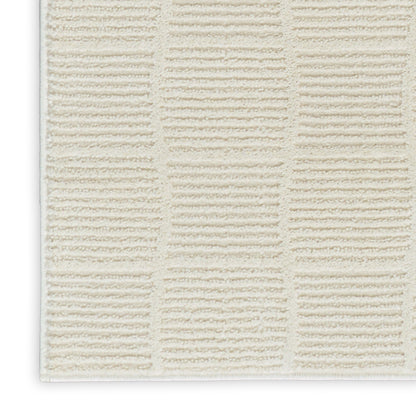 Cream textured bath mat with a grid of tufted rectangular blocks; plush bathroom rug.