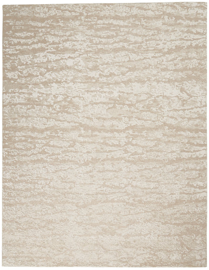 Beige and cream mottled rectangular rug with a soft, textured surface.