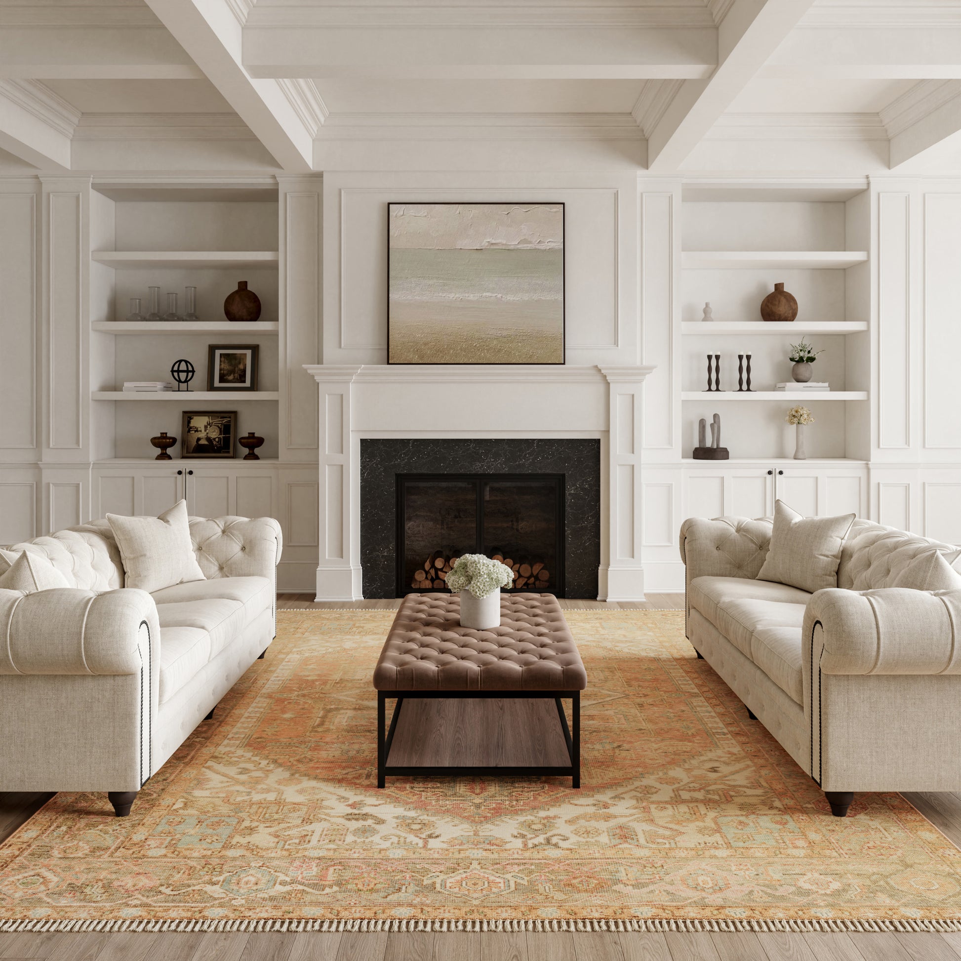 White living room with built-in shelves, a black fireplace, two beige tufted sofas and a brown tufted ottoman on a warm rug.