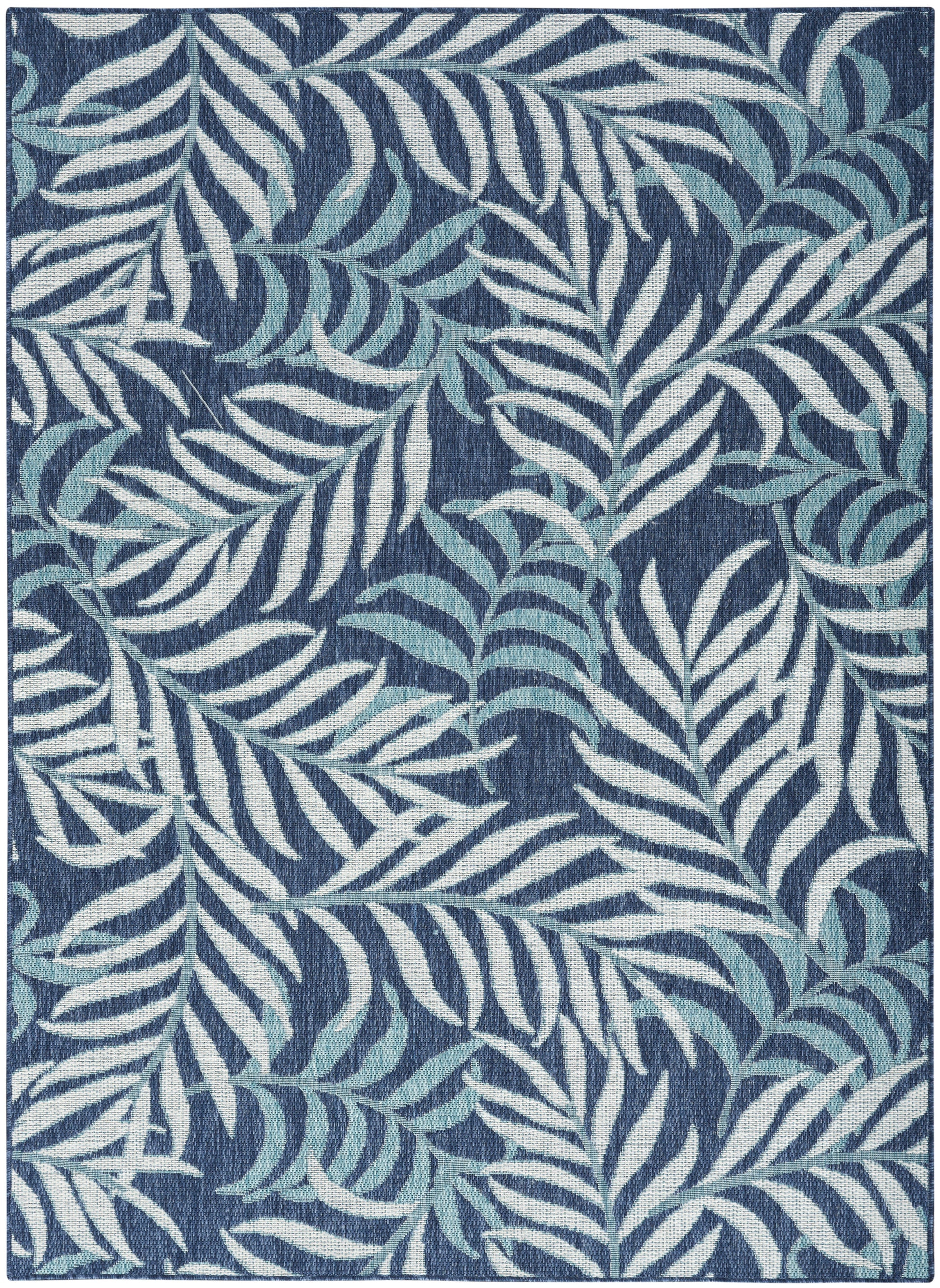 Navy blue rug with a white and light-blue palm leaf pattern.