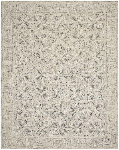 Neutral beige area rug with navy-gray geometric star medallions and maze border; woven texture, rectangular.