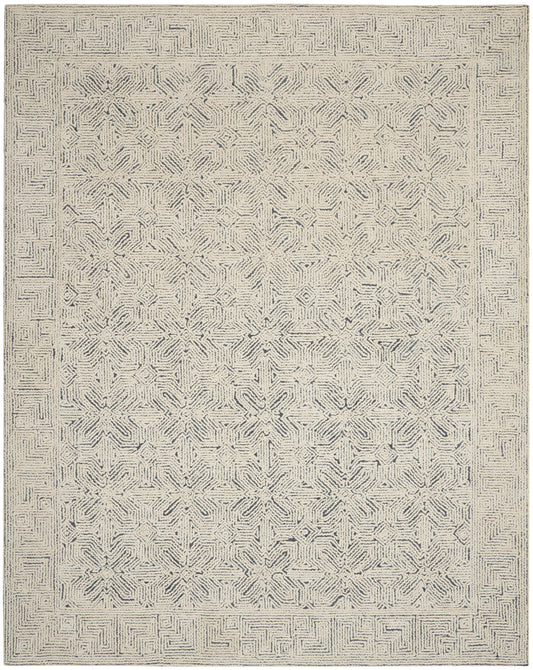 Neutral beige area rug with navy-gray geometric star medallions and maze border; woven texture, rectangular.