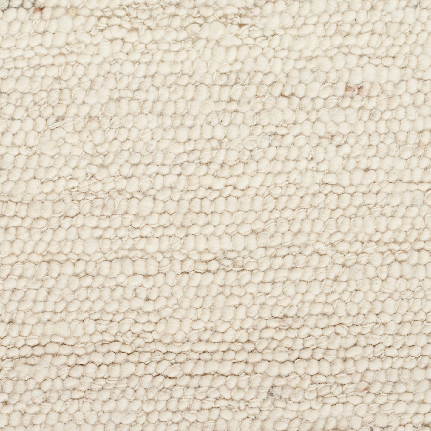 Cream boucle wool rug texture close-up with dense knobby fibers; soft, cozy surface.