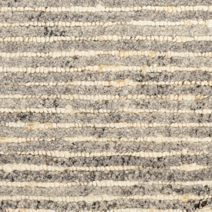 Close-up of a grey and cream striped textured rug with looped pile for cozy modern d??cor.