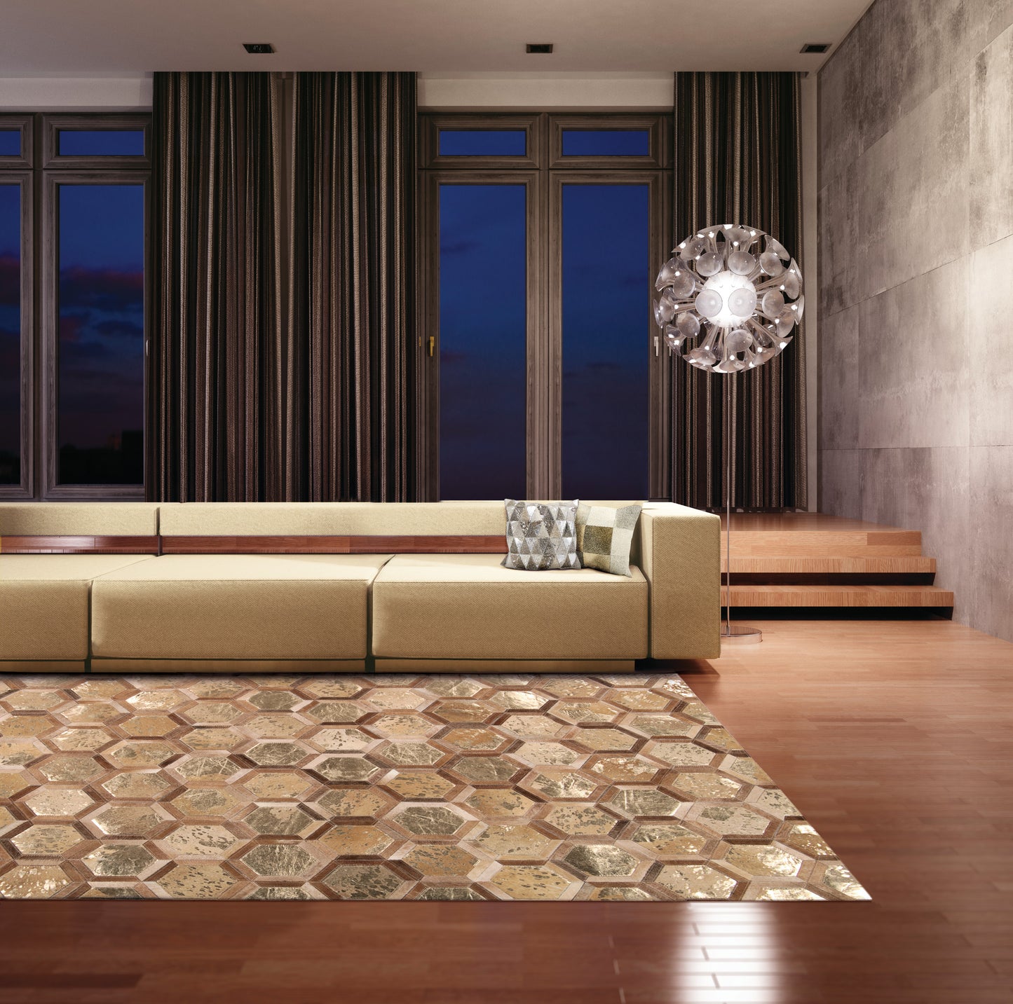 Modern living room with beige modular sofa, metallic hexagon rug, dark curtains, concrete wall, round glass chandelier.