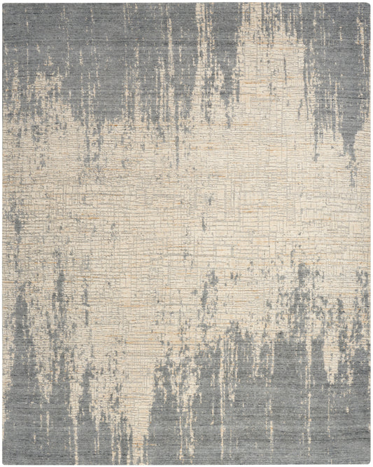 Rectangular area rug with abstract grey and beige distressed pattern and textured finish.