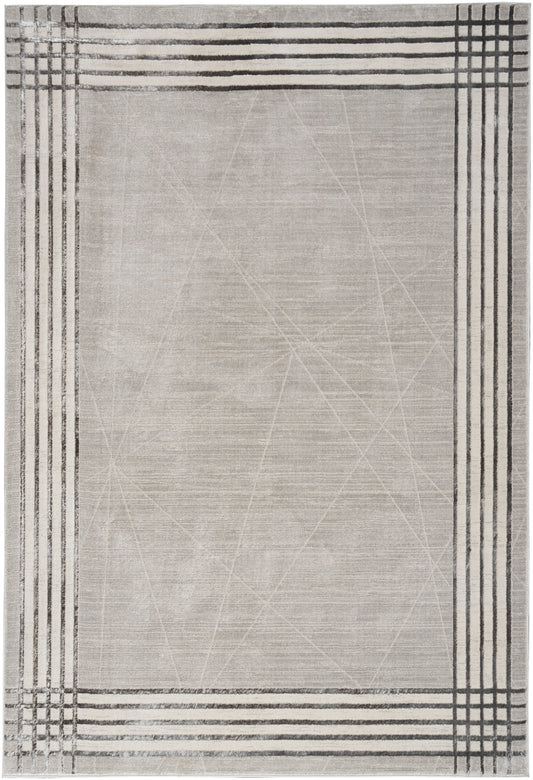 Rectangular light beige rug with dark border stripes forming a plaid frame and subtle geometric lines across the center.